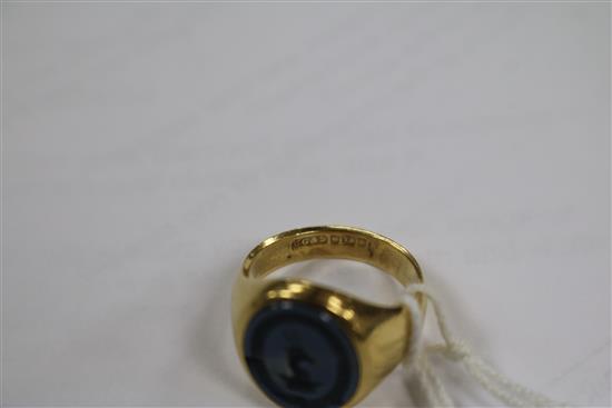 An early 20th century 18ct gold and blue chalcedony signet ring, carved with crested matrix, size L.